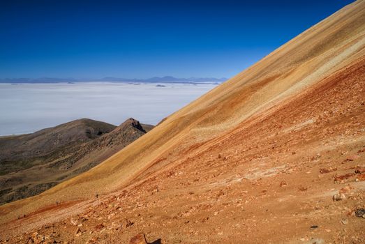 Picturesque view of vast white salt plane Salar de Uyuni from colored mountains