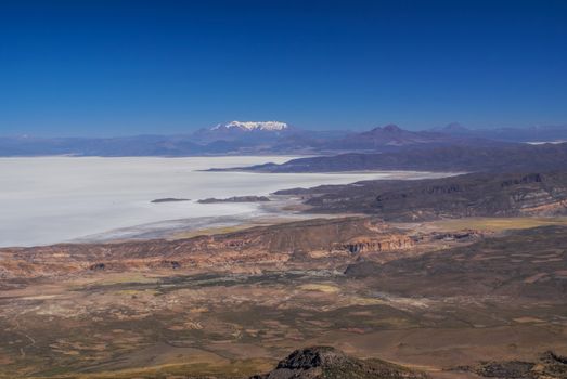 Aerial view of colored mountains and salt plane Salar de Uyuni in Bolivia