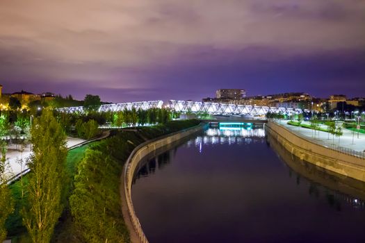 Madrid, Spain - May 8, 2012: Arganzuela Bridge illuminated on a spring night and Madrid Rio Park, Madrid, Spain