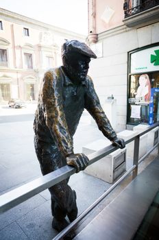 Madrid, Spain - May 9, 2012: Conteporan street sculpture of a person on Calle Almudena in Madrid, Spain