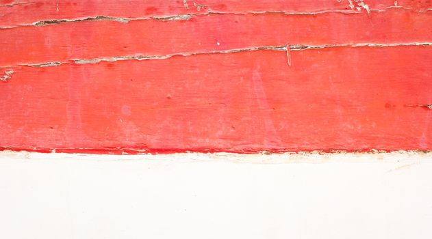 red old wooden wall and white concrete below.