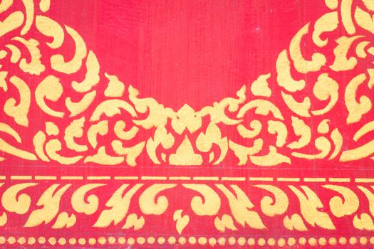 abstract golden pattern on red wall.