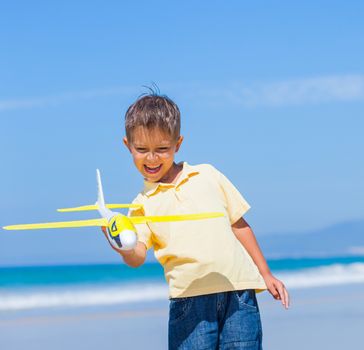 Portrait of beach kid boy kite flying outdoor coast ocean