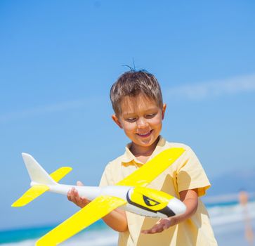 Portrait of beach kid boy kite flying outdoor coast ocean