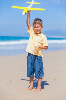 Beach kid boy kite flying outdoor coast ocean