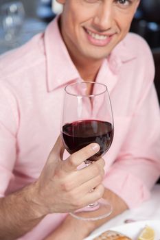 Beautiful man holding a wineglass