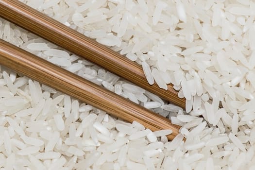 Chopsticks inside a bowl with rice