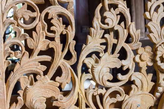 Pattern of flower carved on wood background.