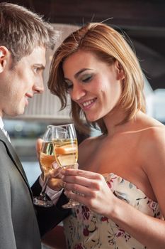 Young couple in love making a toast