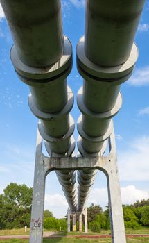 Elevated section of the pipelines with the concrete support against the sky