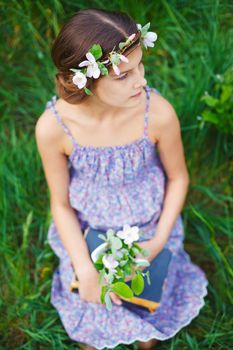 Adorable girl in blooming apple tree garden on spring day