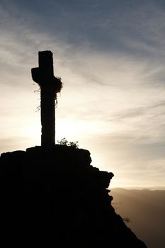 Lonely cross at dawn