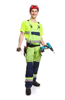 Young handsome contractor holding electric screwdriver and walkie-talkie over white background