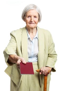 Senior woman giving passport while standing over white