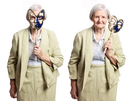 Elderly woman with carnival mask standing over white