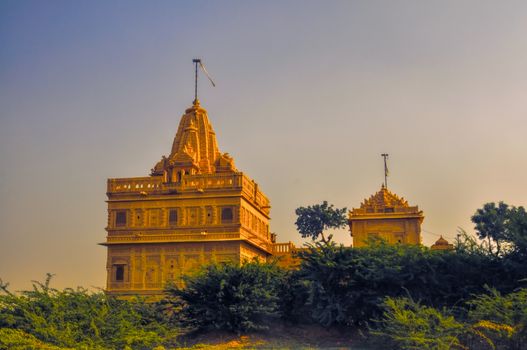 Picturesque view of temple in Thar Desert illuminated by the setting sun