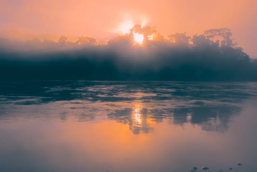 Mystical sunrise above lake in bolivian Andes