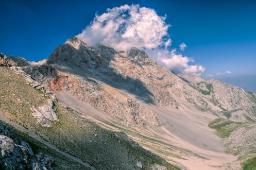 Scenic mountain peaks with forming clouds in Kyrgyzstan