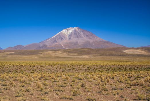 Scenic volcano near salt planes Salar de Uyuni in bolivian desert