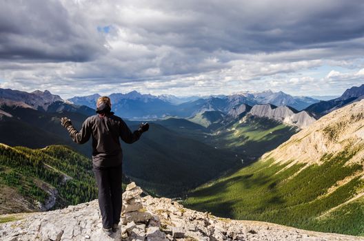 Man enjoying view of Jasper NP mountain range, Alberta, Canada
