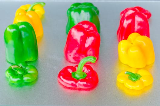Yellow, Red, Green Bell Pepper cut on a silver platter.