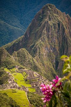 Looking down from Machu Picchu mountain we see the ruins of an ancient city.