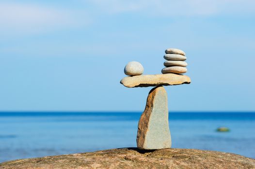 Balancing of pebbles on the top of triangle stone