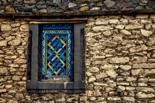 Traditional decorated window on old stone nepalese house