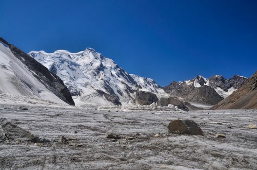 Picturesque landscape on glacier below highest peaks in Tien-Shan mountain range in Kyrgyzstan