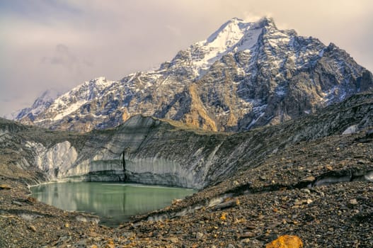 Lake on Engilchek glacier under peaks of scenic Tian Shan mountain range in Kyrgyzstan