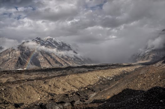 Heavy rainclouds forming above Engilchek glacier in Tian Shan mountain range in Kyrgyzstan