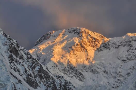 Scenic Pik Pobeda peak lit by early morning sun in Kyrgyzstan