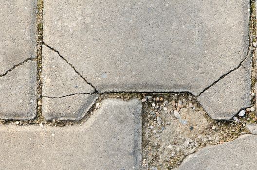 Crackled stone pave with dirt, concrete path texture.