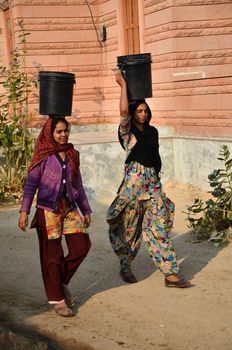 Jodhpur, India - January 1, 2015: Indian women going for the water in well of village, Jodhpur, Rajasthan, India. Jodhpur is the second largest city in the Indian state of Rajasthan with over 1 million habitants.