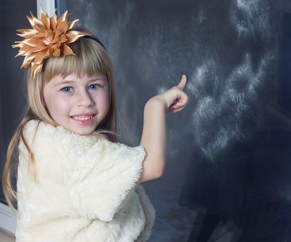 Image of youthful girl looking at it behind window