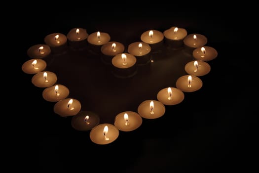 Heart of candles, a sign of love. romantic evening