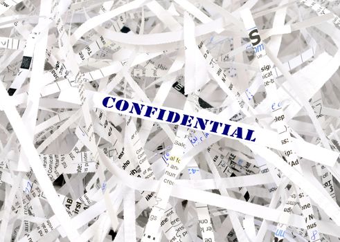 Confidential text surrounded by shredded paper. Great concept for information protection