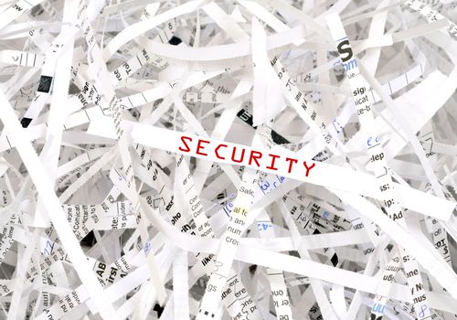 Security text surrounded by shredded paper. Great concept for information protection