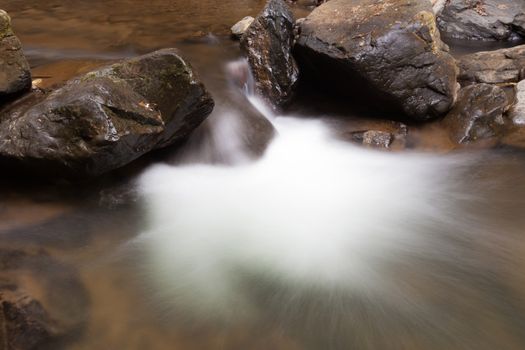 Waterfall that flows down from the mountains. Streams of water flowing down from the mountains. There is always a small stone waterfall.