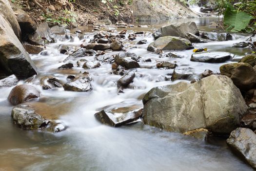 Waterfall that flows down from the mountains. Streams of water flowing down from the mountains. There is always a small stone waterfall.