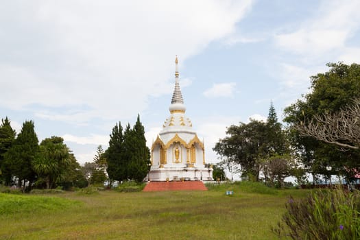 White pagoda. Close to the grass. The sky was clear in the morning.