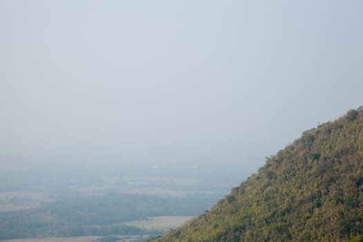 tree covered peaks. Fog in the morning. ForestCovered mountains around