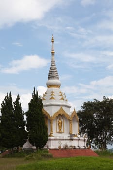 White pagoda. Close to the grass. The sky was clear in the morning.