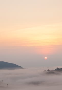 sunrise and mist covered mountains. In the morning, a cold and fog shrouded the mountains and trees.