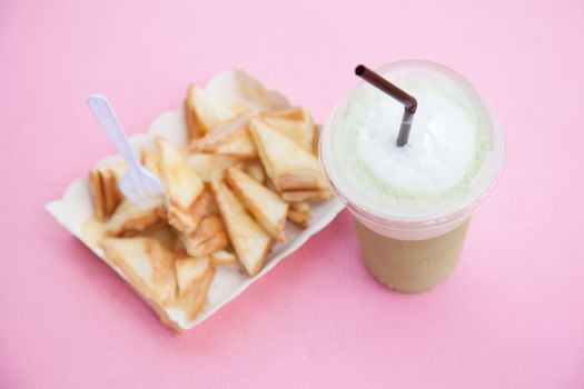 Frappe coffee and toast. Eat a snack. Coffee and bread on the table.