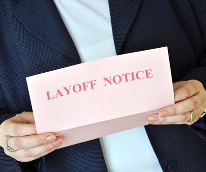 Female executive reading a layoff notice from her employer