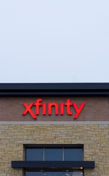 MAPLEWOOD, MN/USA - JANUARY 20, 2015: Xfinity retail store and sign. Xfinity provides cable television, broadband internet, and voip telephone.