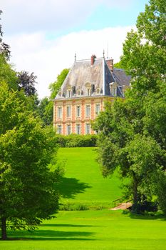 Beautiful mansion on hill of golf course at sunny day