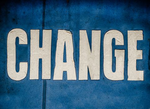 A Grungy Blue Conceptual Sign Saying Change In White Letters