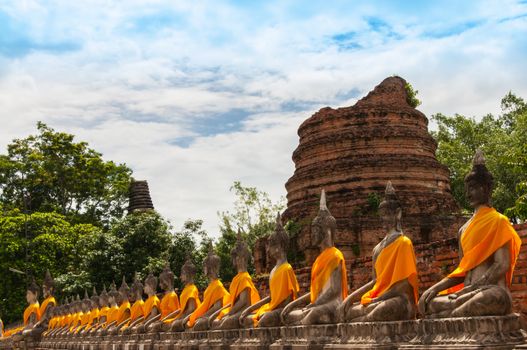 AYUTTHAYA,THAILAND-JUNE 27, 2013: Aligned statues of Buddha in Watyaichaimongkol